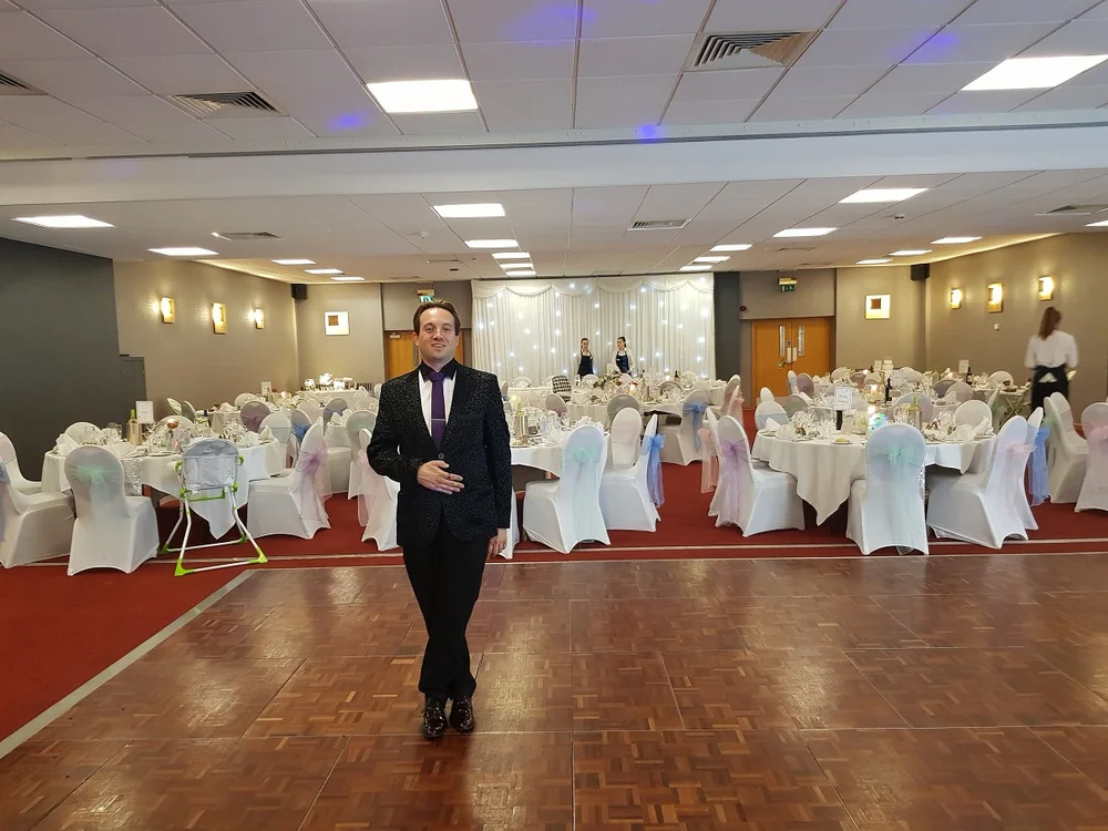 Matthew Garrett performing close-up magic at Cranfield University in Bedfordshire