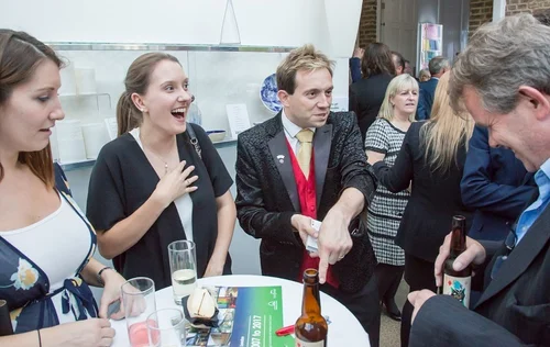 Guests reacting to Matthew Garrett performing magic at a corporate event