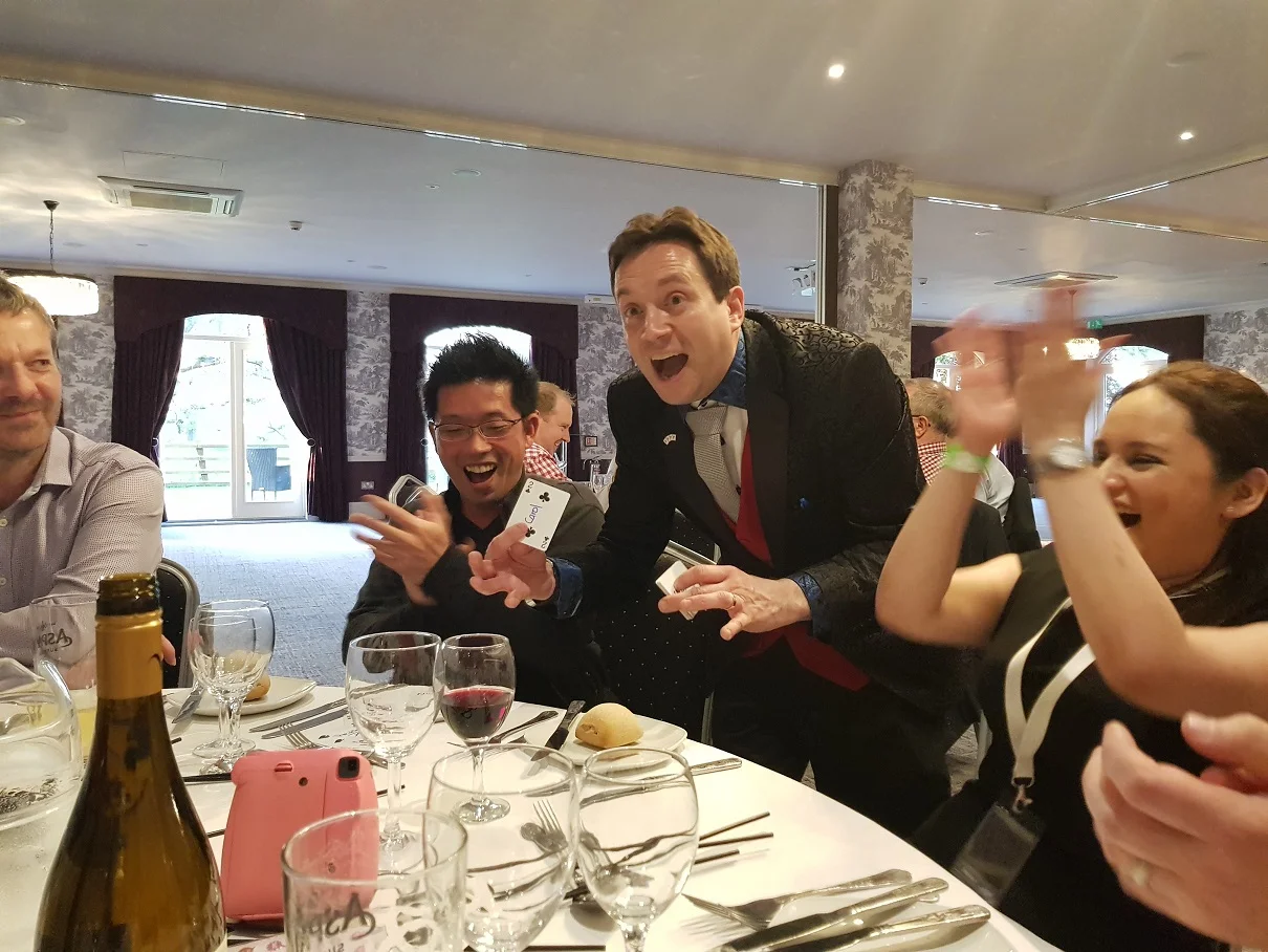 Close-up magician entertaining guests at an event