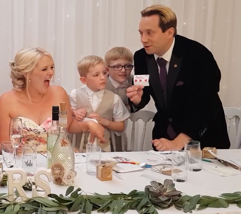 Guests reacting to Matthew Garrett's close-up magic at Skylark Farm