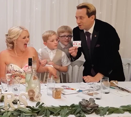 Bride reacting to close-up magic performed by Matthew Garrett at a wedding