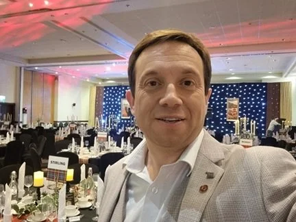 Matthew Garrett, award-winning wedding host and magician, standing in a beautifully decorated wedding reception venue before guests arrive, helping couples create unforgettable wedding celebrations.