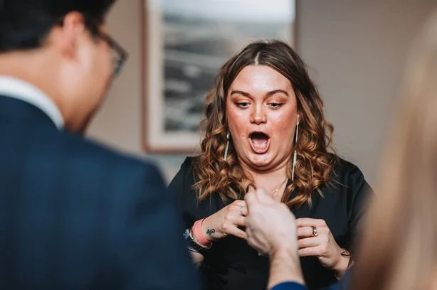 Guests reacting to Matthew Garrett performing close-up magic at an event in Ipswich