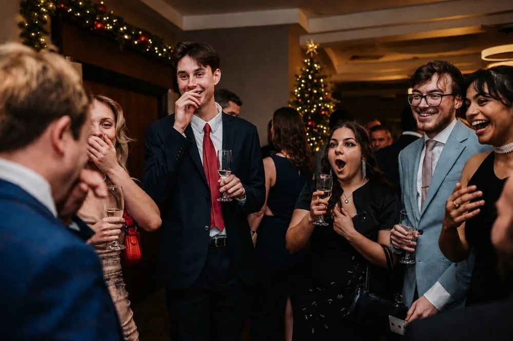Matthew Garrett performing close-up magic at a Christmas event