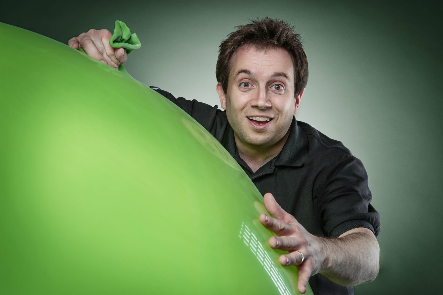 Stage magician climbing into a large inflated balloon during a live performance