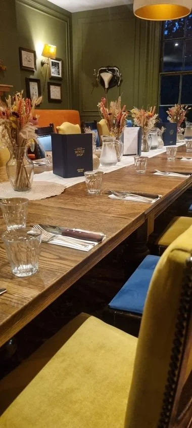 Dining tables prepared for an event at The Old Bicycle Shop in Cambridge