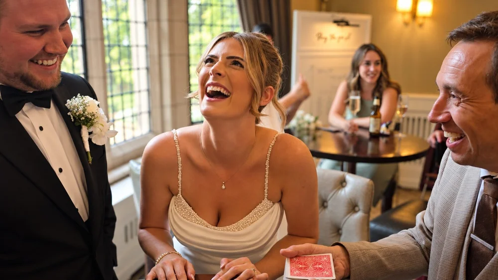 Bride reacting to wedding magician Matthew Garrett at Moxhull Hall