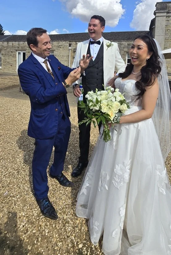 Bride and groom enjoying close-up wedding magic at Barton Hall