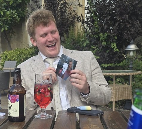 Wedding guest enjoying close-up magic at Barton Hall in Kettering