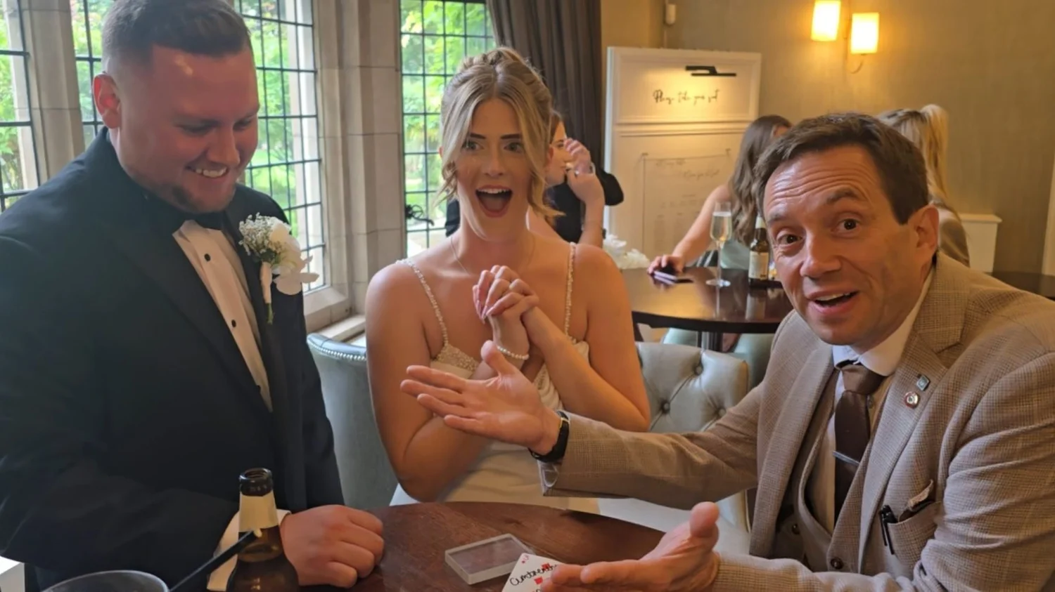 Wedding magician Matthew Garrett performing close-up magic for the bride and guests at Moxhull Hall