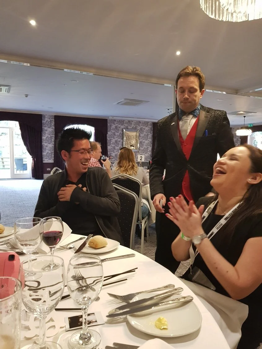 Guests reacting to Matthew Garrett performing close-up magic at Woughton House Milton Keynes