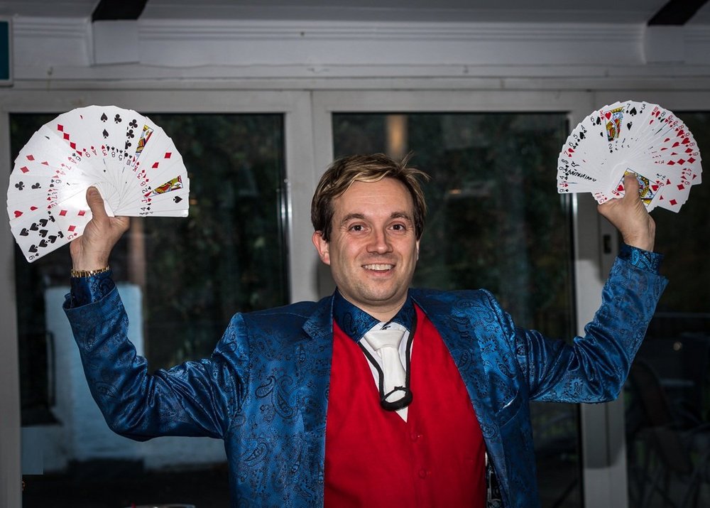 Matthew Garrett performing stage magic with fans at Bushey Hall Golf Club