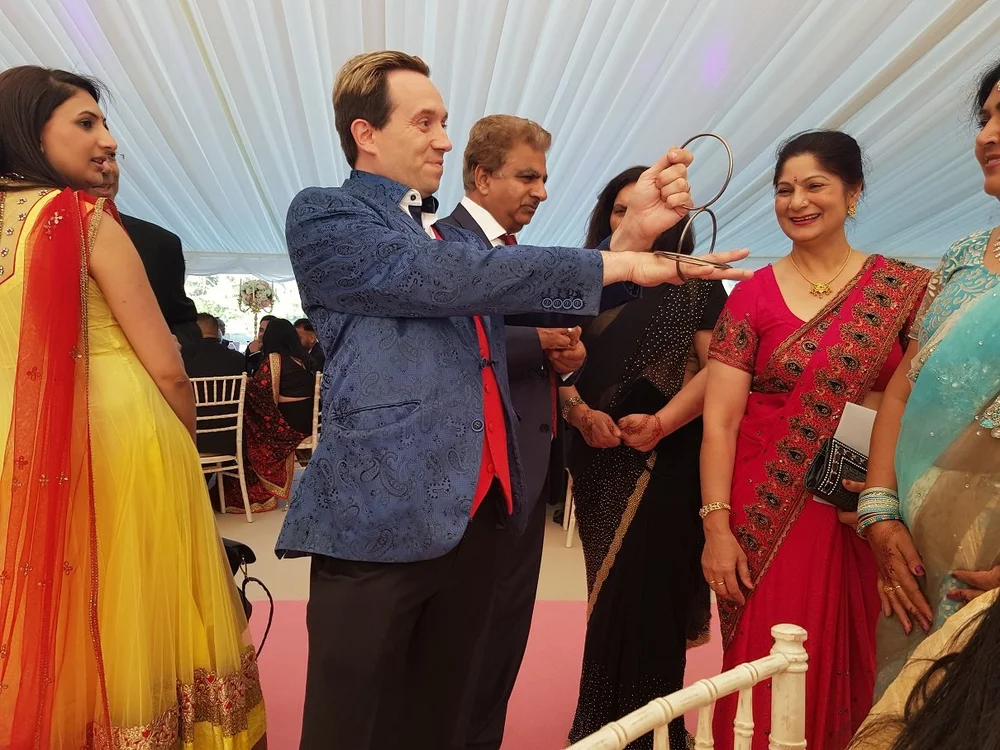 Matthew Garrett performing close-up magic at Courteenhall Estate in Northamptonshire