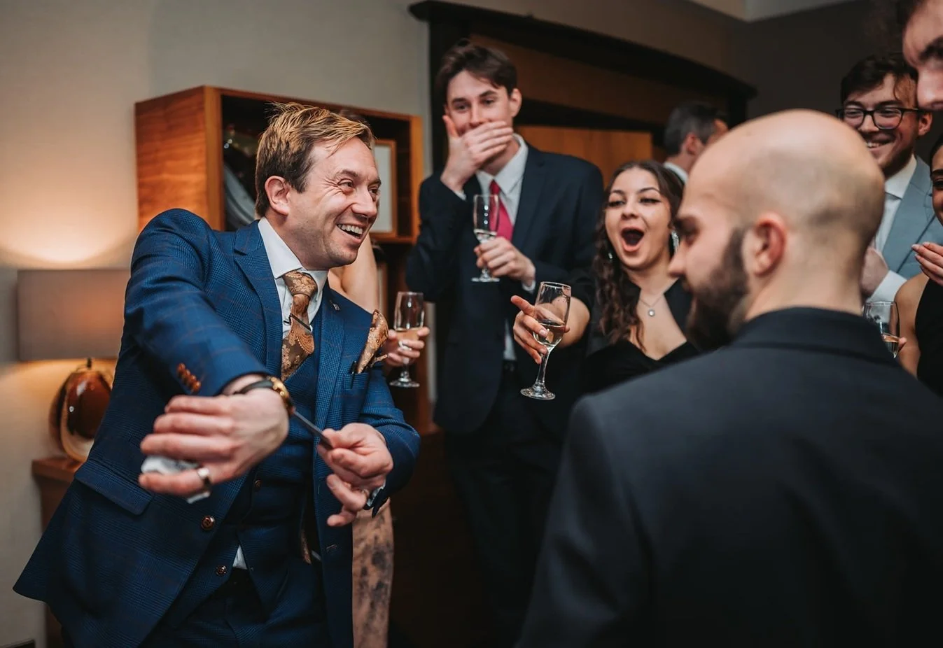Guests reacting to close-up magician Matthew Garrett at an event in Derby