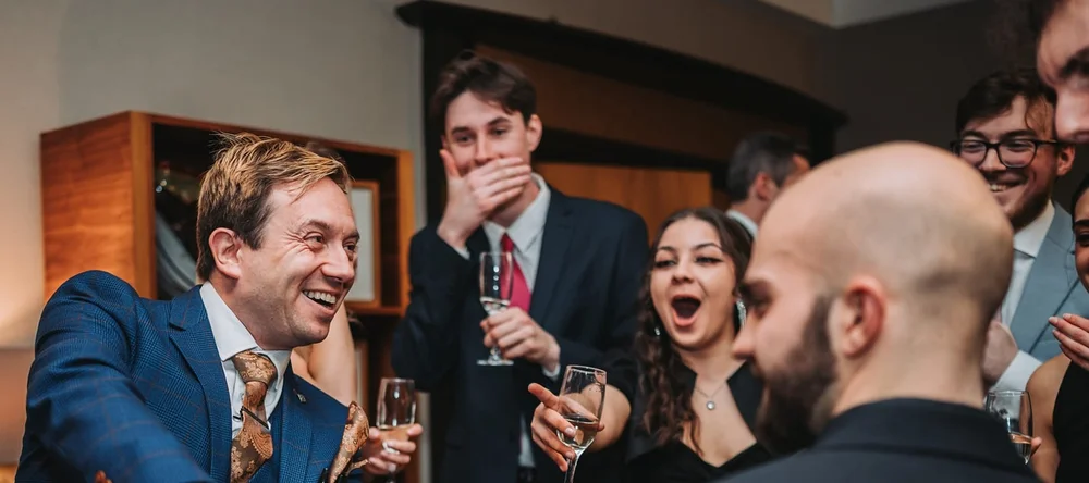 Matthew Garrett performing close-up magic for guests at an event
