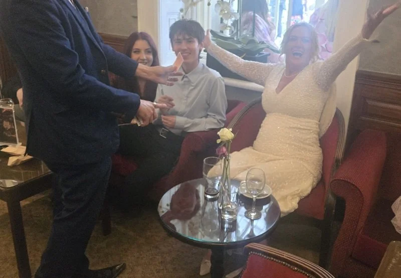 Bride reacting to Matthew Garrett's close-up magic at her Dovecliff Hall wedding