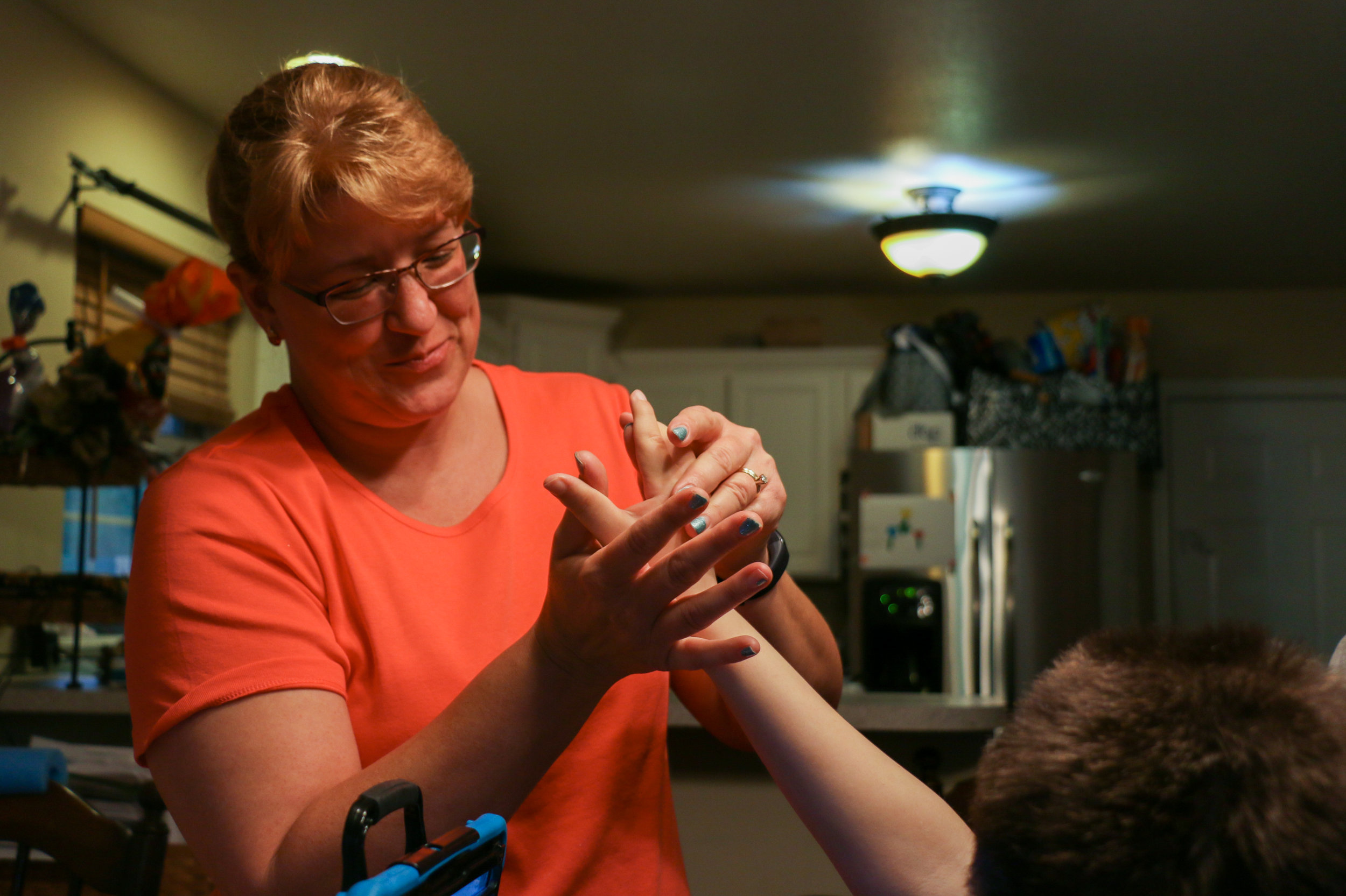   Gretchen Hein-Roberts relaxes and massages her 12-year-old son Blake’s hand in Columbia, Missouri, on Monday, Oct. 31, 2016. Gretchen said that Blake has multiple severe disabilities, and is concerned about her son developing relationships with his