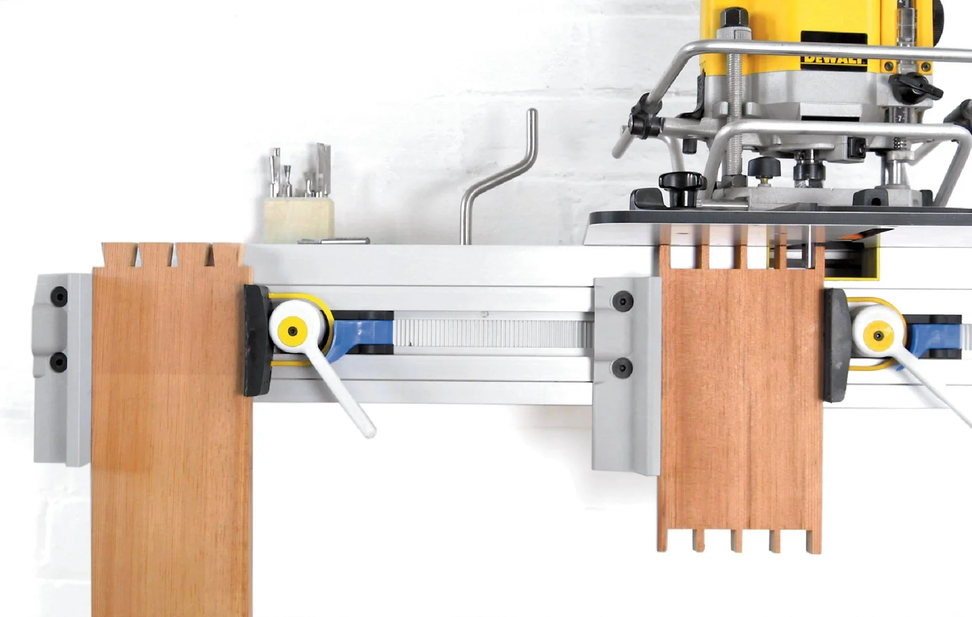 Cutting dovetails on the WoodRat router joinery machine, with boards clamped in the guide rails