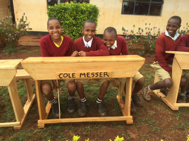  Primary students at Haymu School with a new desk donated in memory of Cole Messer 