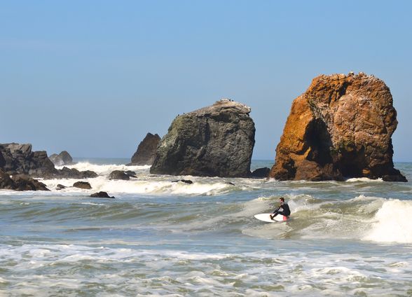 A surfer at Rockaway Beach (©Visit Pacifica)