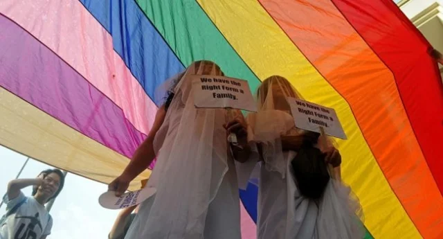 Supporters of same-sex marriage protest in wedding dresses (Photo by NOEL CELIS/AFP/Getty Images)