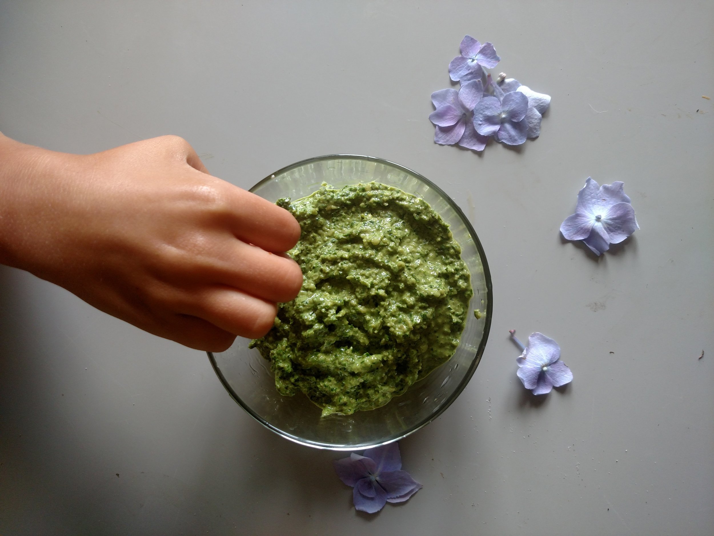 My daughter, sneaking some pesto from the bowl!