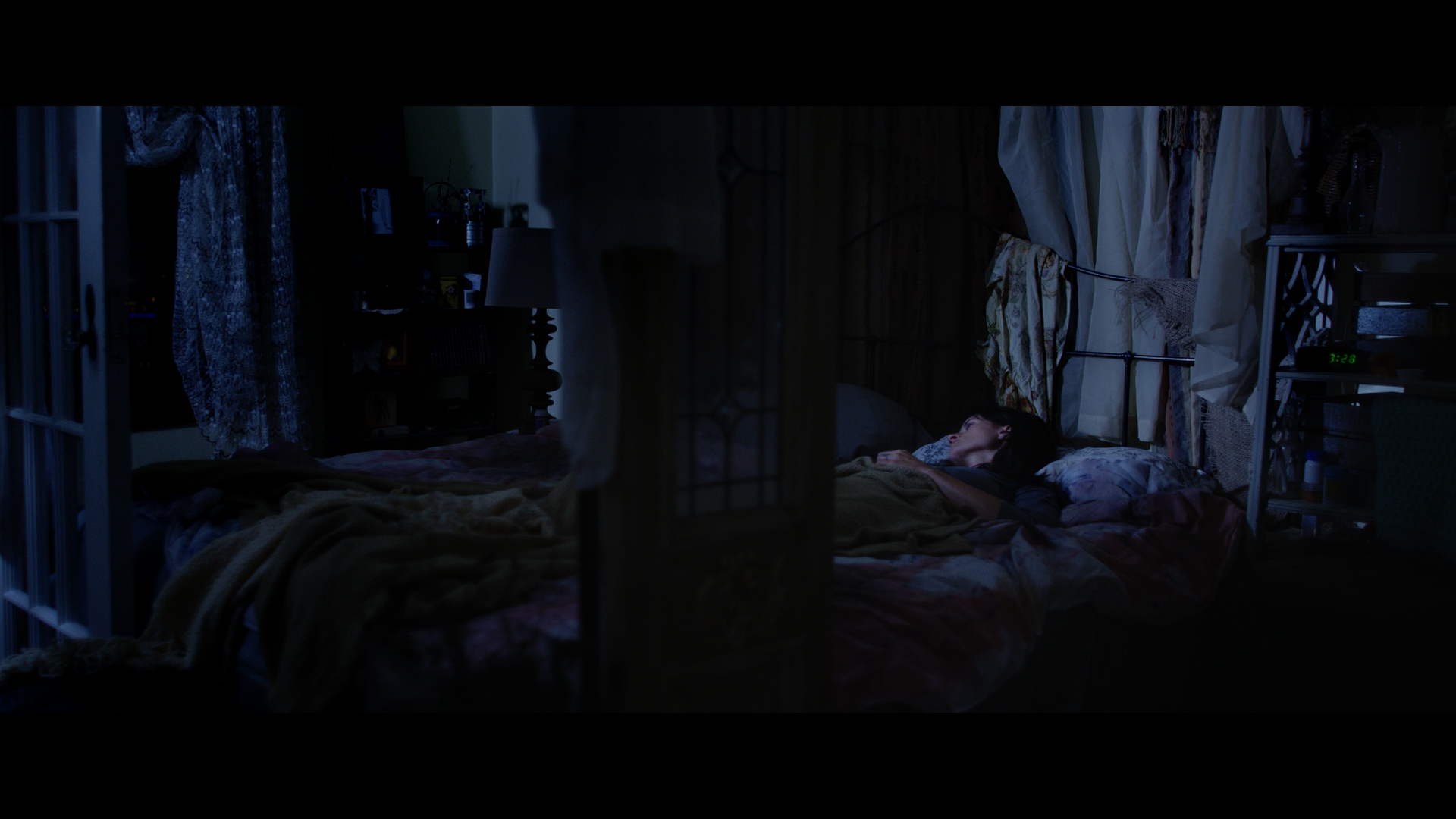 I am not a fan of showing before and after images between LOG and a final grade, so you'll have to imagine what it would have been like as a RAW Dragon file. I adjusted ISO and Col Temp from the R3D metadata to knock down the exposure and cool the picture. I always then label the first Node RAW, as a reminder that I have RAW metadata changes on this shot. A tough shot to grade as it has to be dark, but on the other hand we need to see her. This is achieved with lots of window shapes, both darkening and desaturating areas, this means she will automatically pop out of the picture. TIP. Always review at Realtime and check for any obvious windows.
