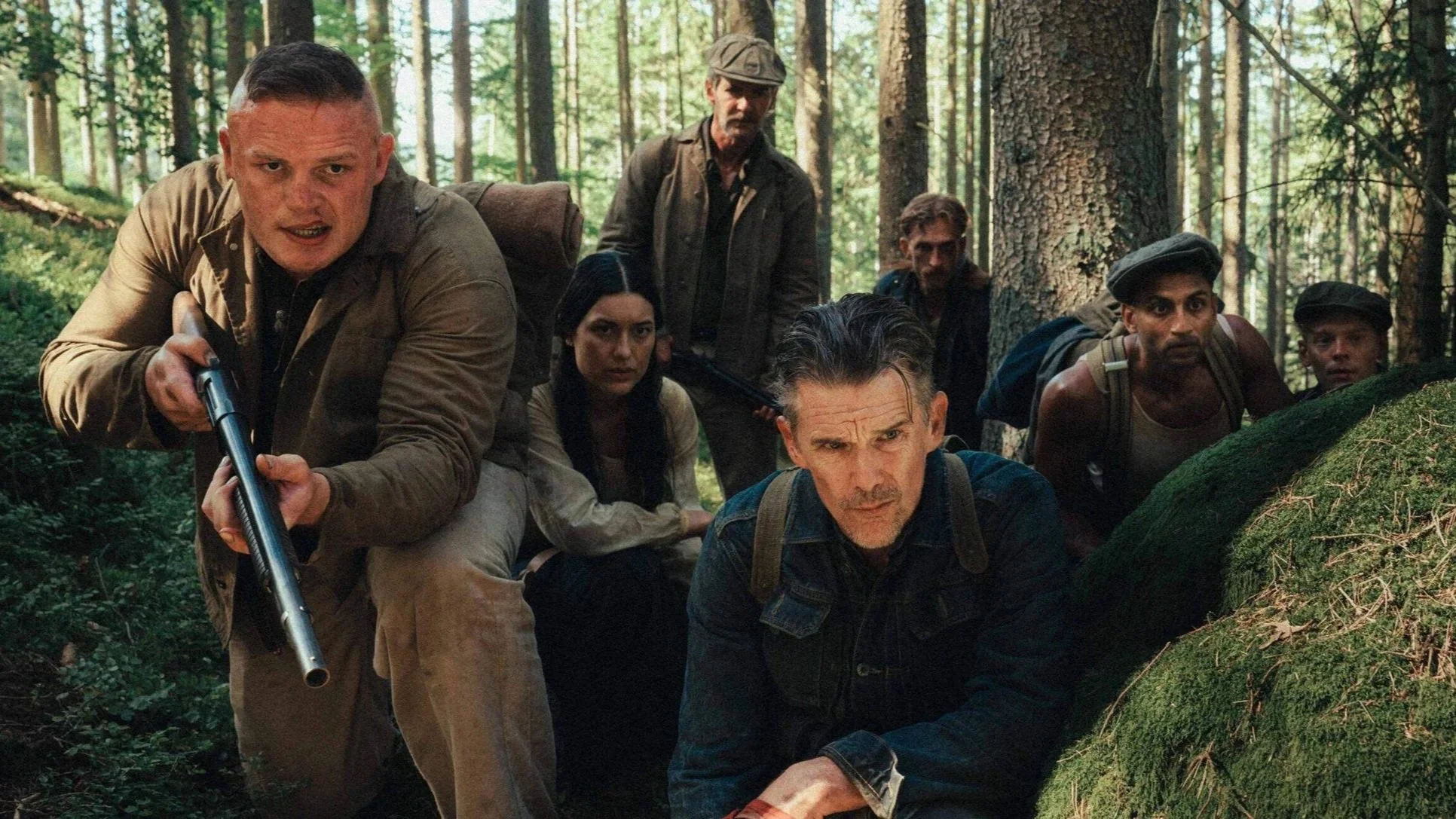 (From left to right) Letender (played by George Burgess), Anna (Julia Jones), Amis (Sam Hazeldine), Murphy (Ethan Hawke), Rankin (Austin Amelio), Singh (Avi Nash), and Olson (Lucas Lynggaard Tønnesen) all gather in the forest in the film The Weight.