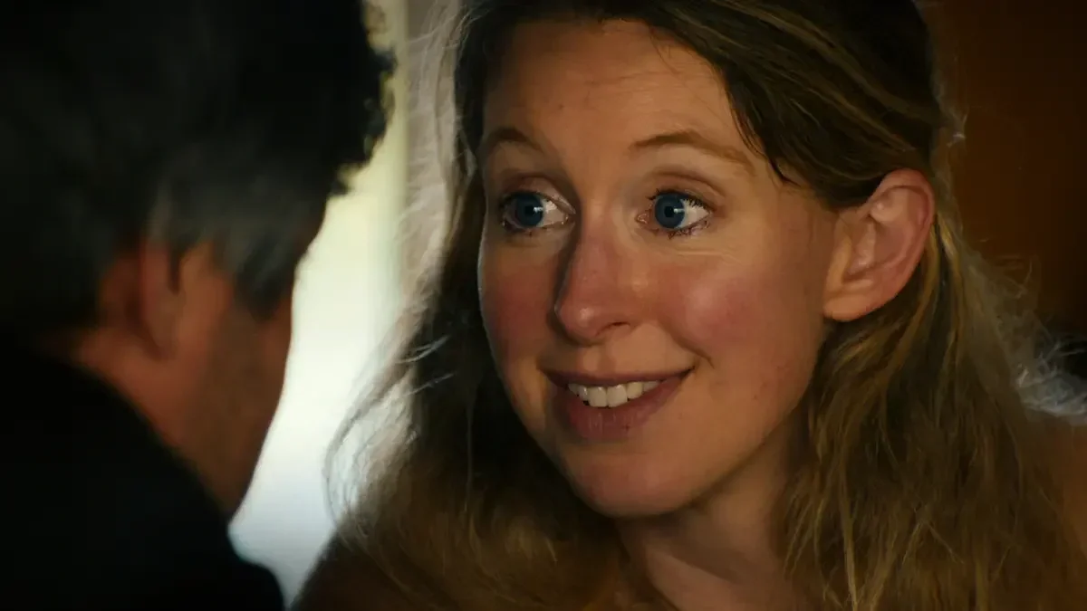 Disgraced Silicon Valley founder Elizabeth Holmes stares wide-eyed at filmmaker Nathen Fielder in the film You Can See Everything.