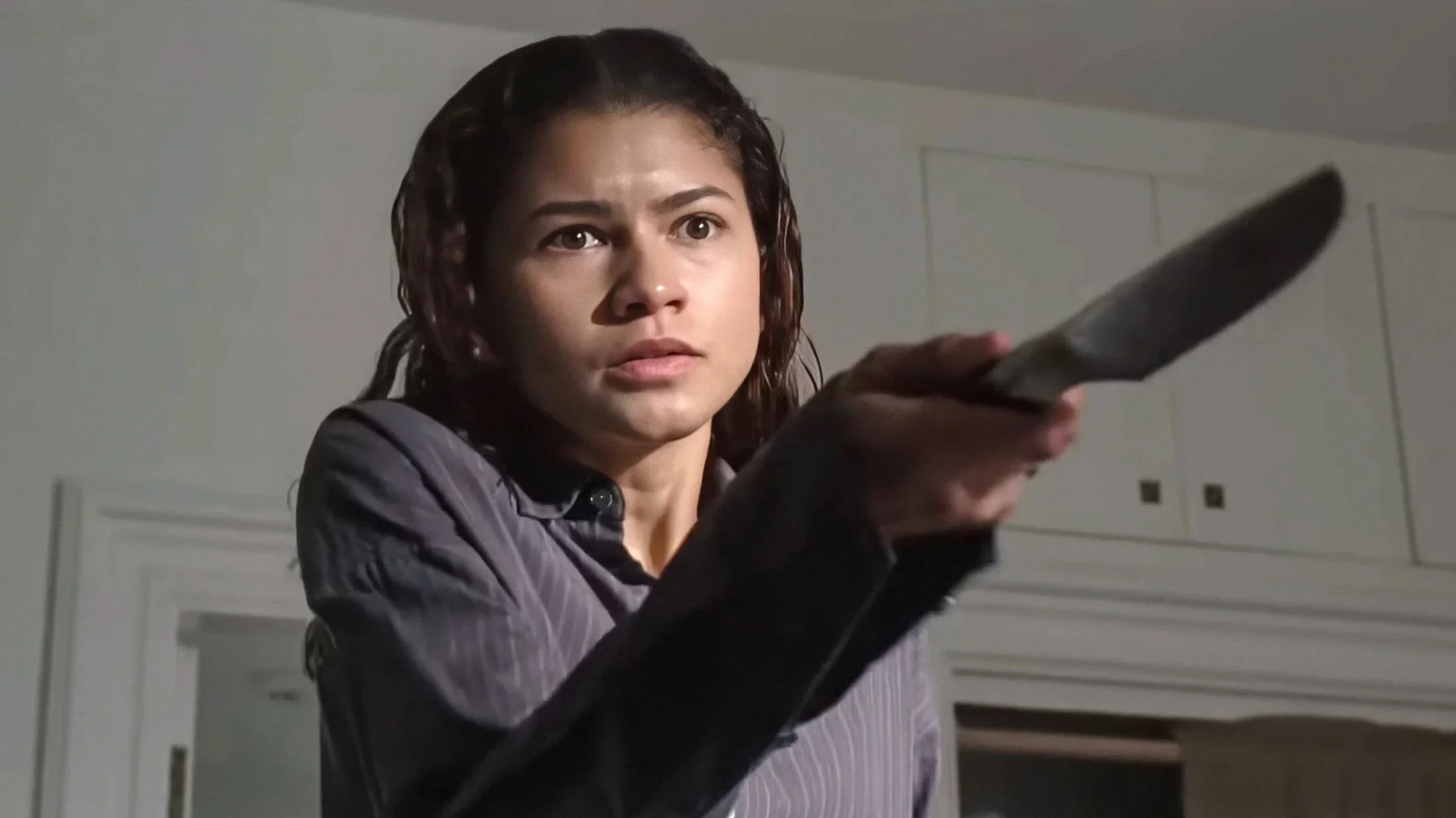 Emma (Zendaya) points a knife towards someone off-screen in 'The Drama.'
