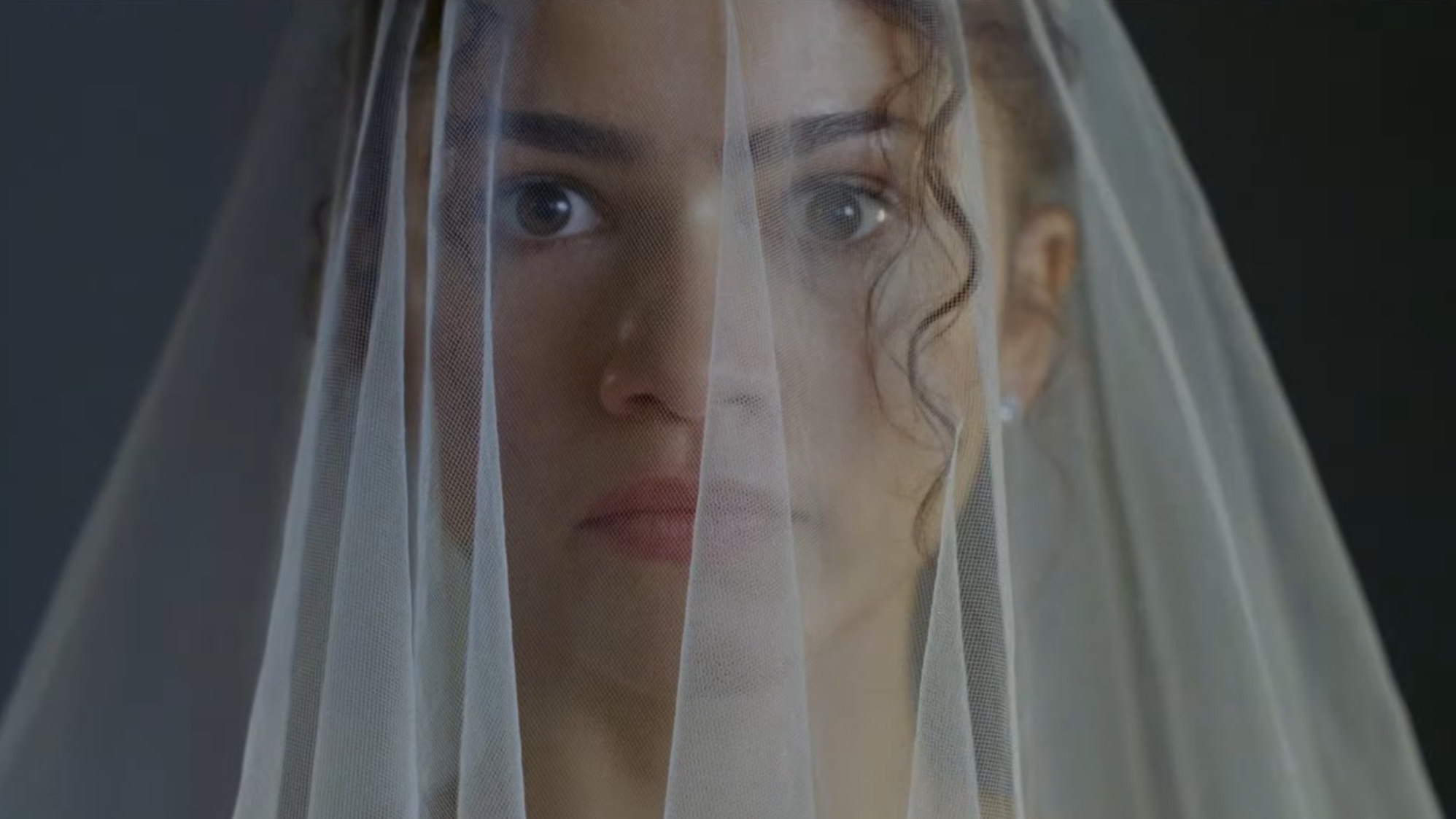 Emma (Zendaya) has a wide eye gaze towards the camera while wearing her wedding veil in 'The Drama.'