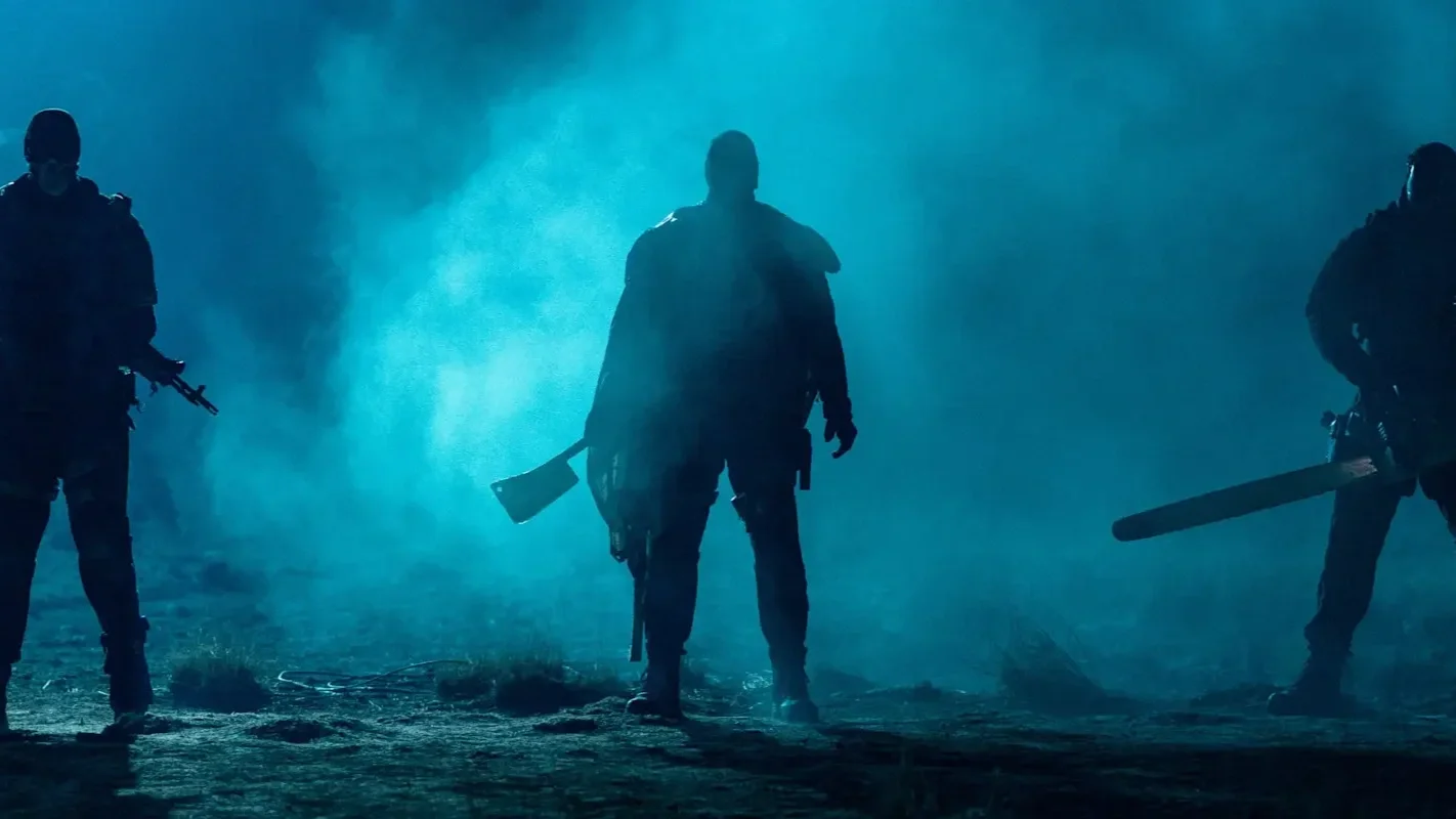 The three super-soldiers stand menacingly in a foggy field in the film Onslaught.