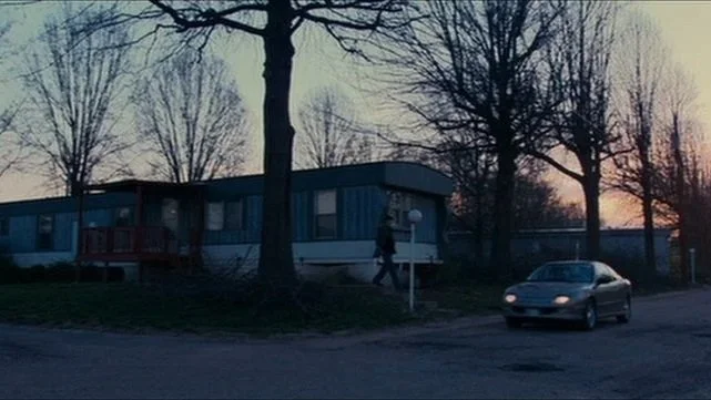 Exterior shot of a mobile home neighborhood during sunrise in the movie Bubble.