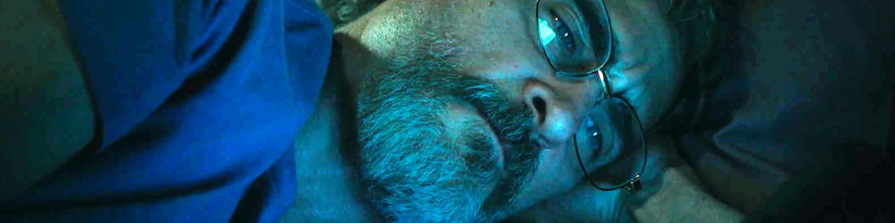 Joaquin Phoenix lays in bed doomscrolling in Eddington.