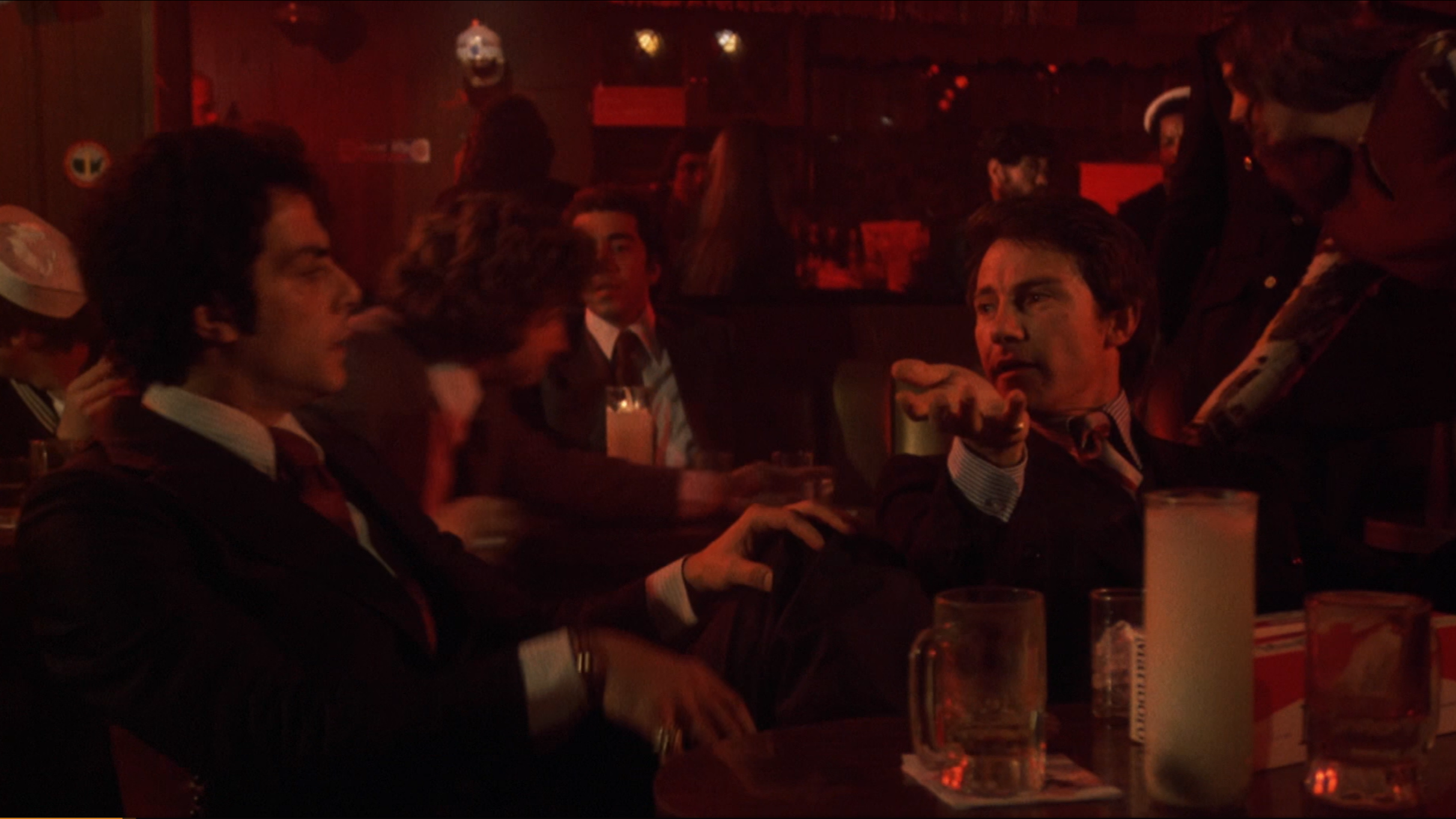 Richard Romanus talks to Harvey Keitel in a bar in the film 'Mean Streets'.