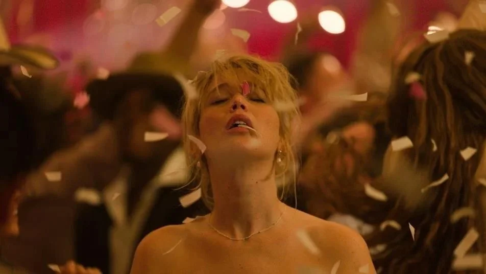 Jennifer Lawrence stands with her eyes closed as confetti rains down in 'Die My Love.'