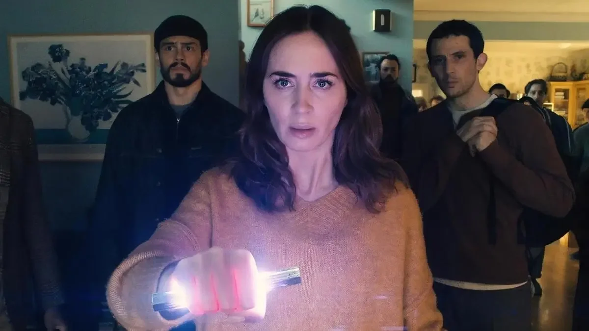 Tommy Martinez, Emily Blunt, and Josh O'Connor look into the camera with confused expressions. Blunt holds a glowing object in her hand.