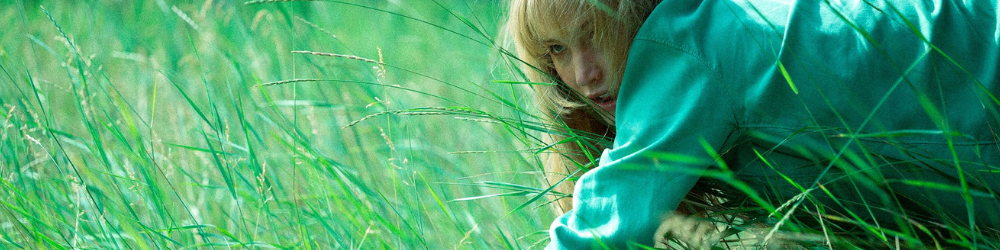 Jennifer Lawrence crawls in the grass in Die My Love.