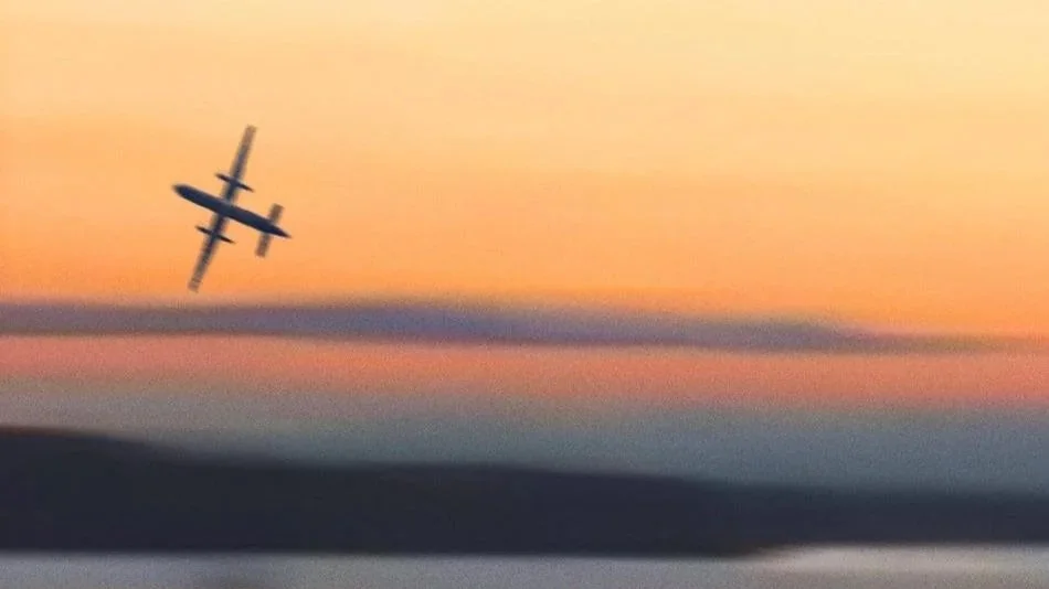 A blurry plane flies through an orange sunset from the film, #SKYKING.