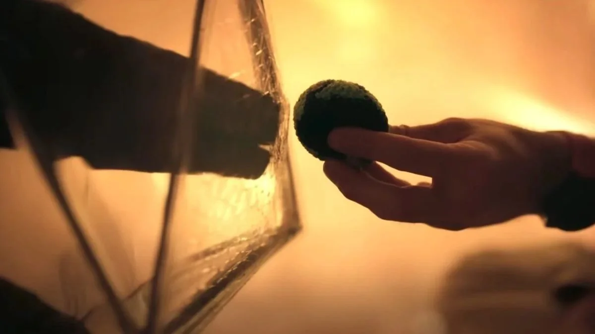 Rocky the alien and Ryan Gosling almost touch hands in the film Project Hail Mary.