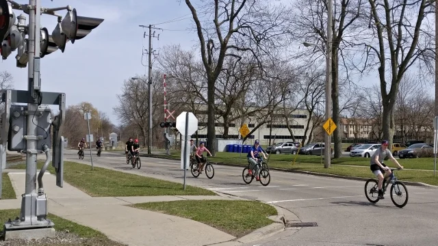A group of boys enjoying a ride on a quiet street in downtown London on a warm spring day. I'd call this crew "enthusiastic and confident."