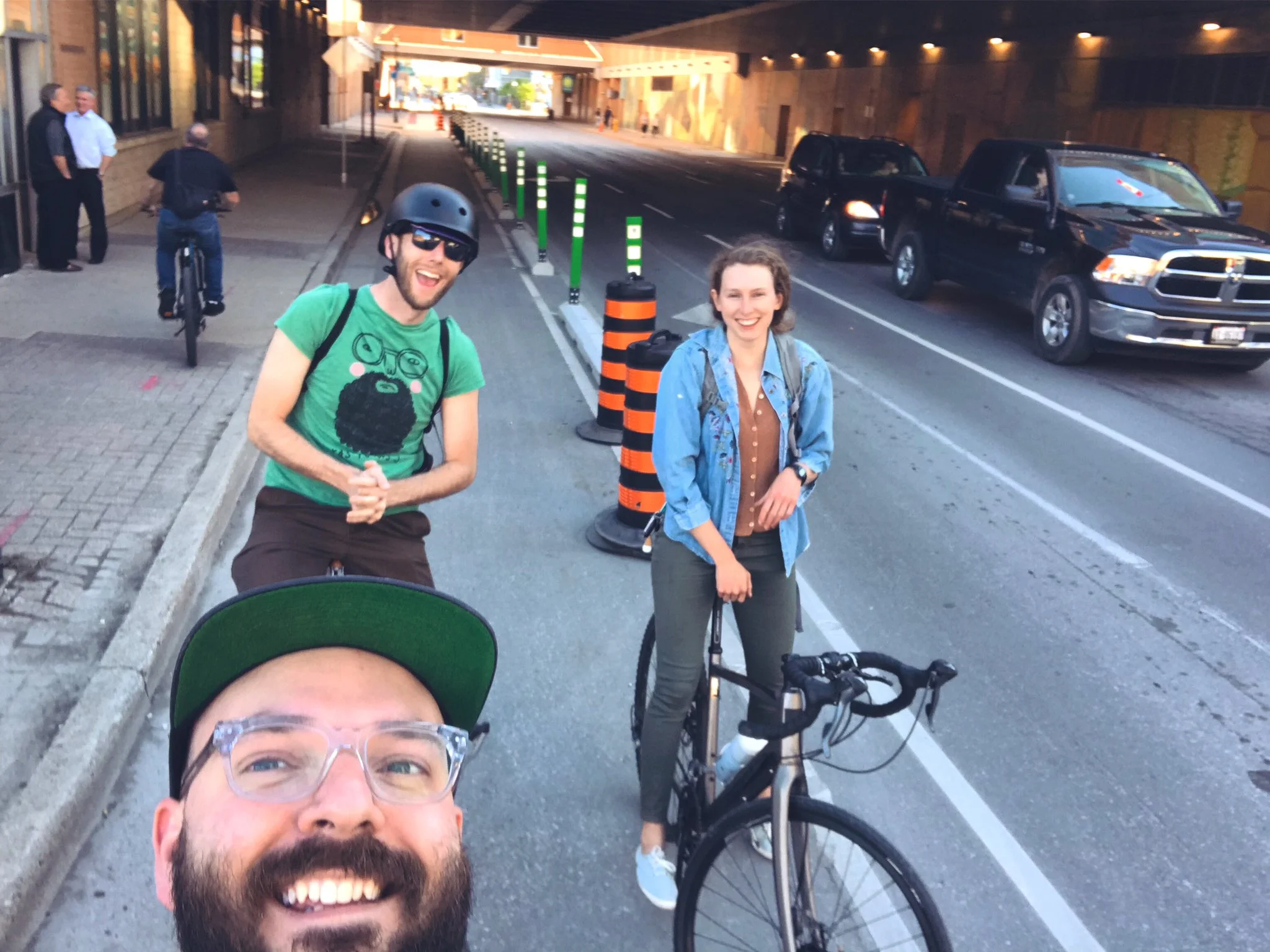 Smiling happy people in the King Street protected bike lane! (Photo: @stevemacdouell )
