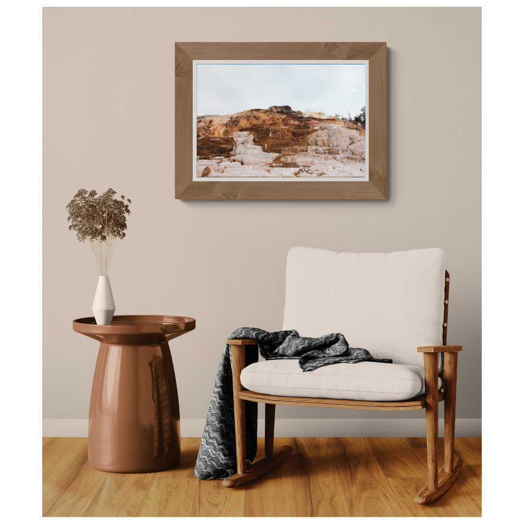 Yellowstone Mineral Terraces fine art print, framed and matted, styled in a room next to a chair, Britt Vasina Studio
