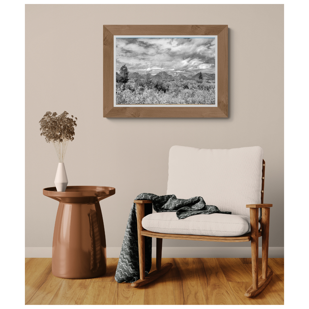 Grand Teton High Plains black and white fine art print, framed and matted, styled in a room next to a chair, Britt Vasina Studio