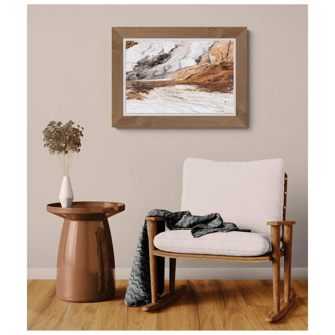 Yellowstone Mineral Slopes fine art print, framed and matted, styled in a room next to a chair, Britt Vasina Studio