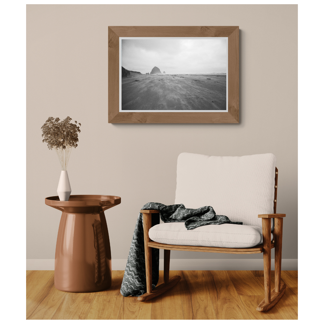 Wind-swept Cannon Beach shoreline fine art print framed in light wood on a neutral wall with matte print and border, Britt Vasina Studio
