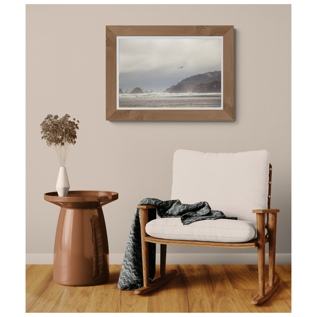 Ecola State Park Rocky Coastline fine art print, framed and matted, styled in a room next to a chair, Britt Vasina Studio