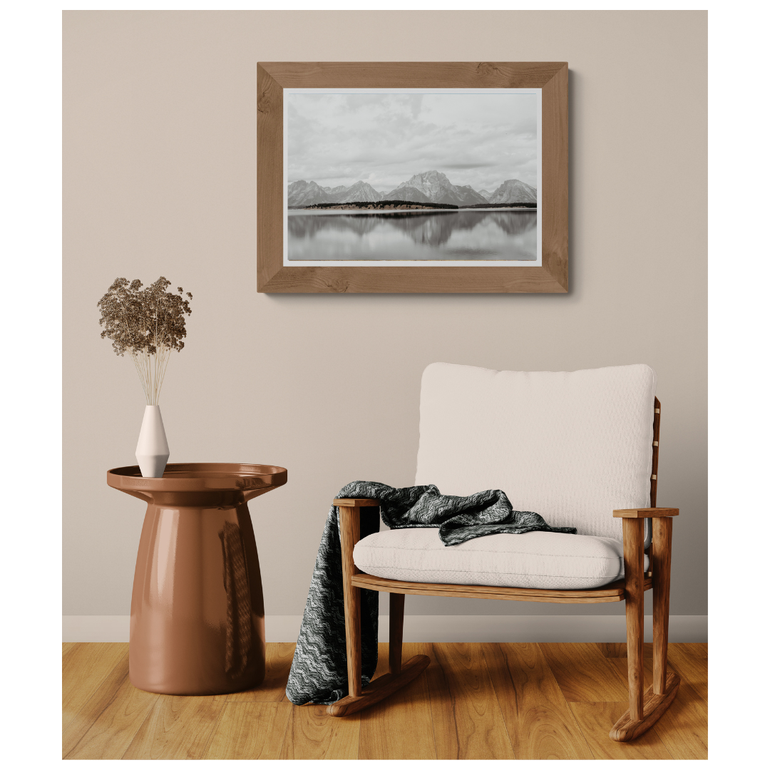 Jenny Lake Stillwater Peaks fine art print, framed and matted, styled in a room next to a chair, Britt Vasina Studio