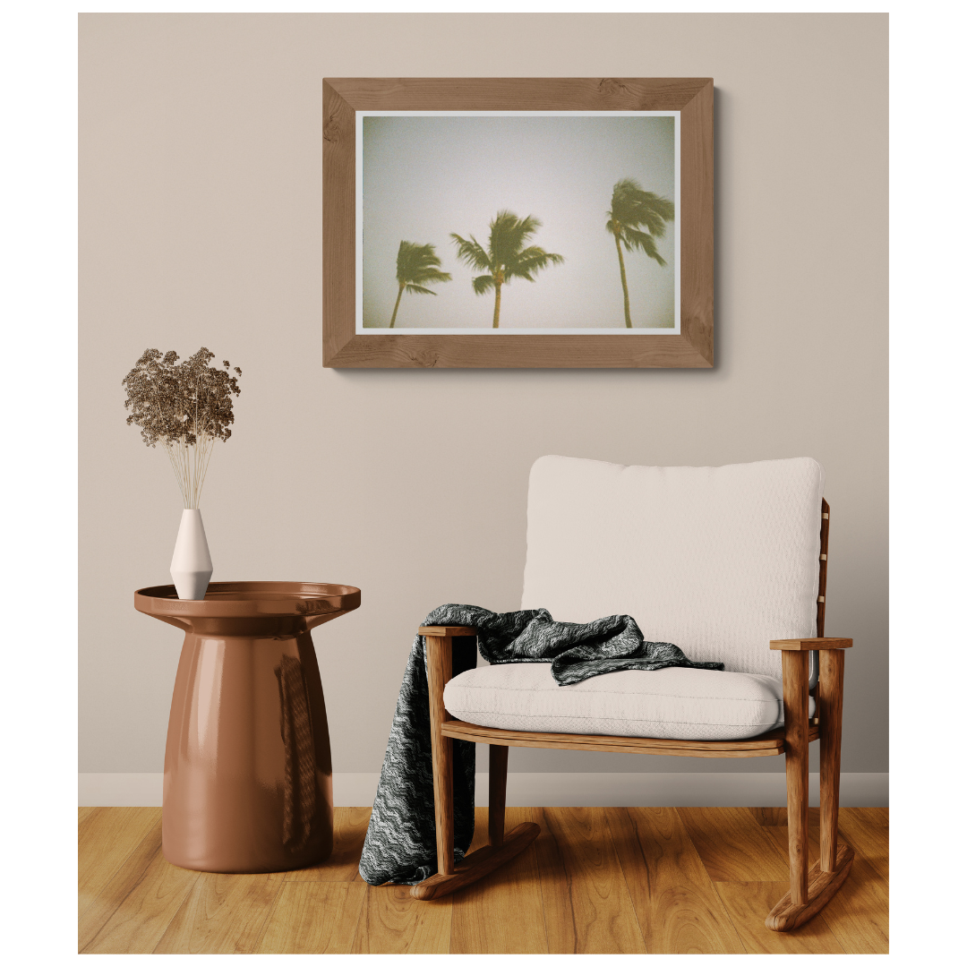 Windblown palm trees matte fine art print framed in light wood on a neutral wall, Britt Vasina Studio