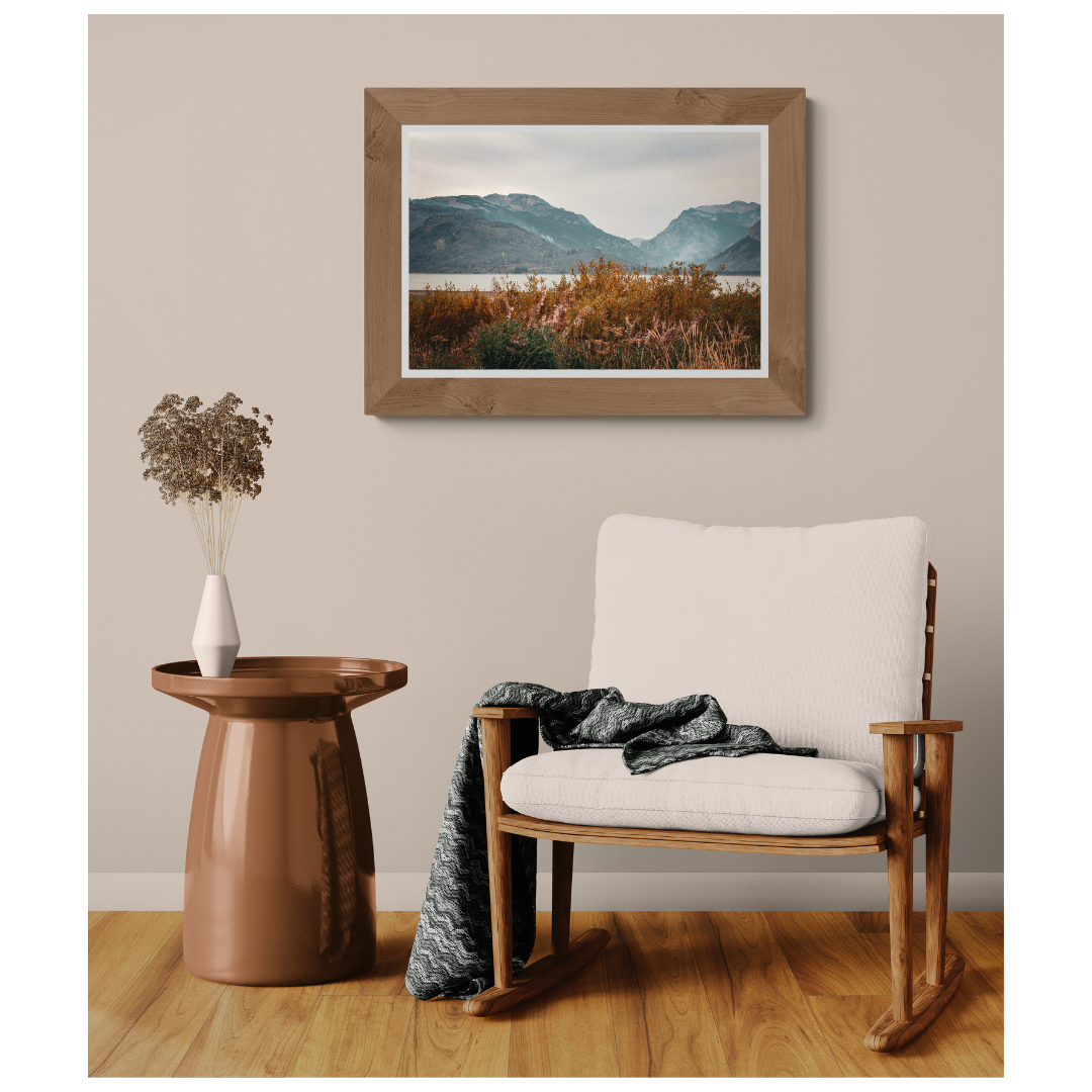 Autumn Wilderness Alaska landscape fine art print, framed and matted, styled in a room next to a chair, Britt Vasina Studio